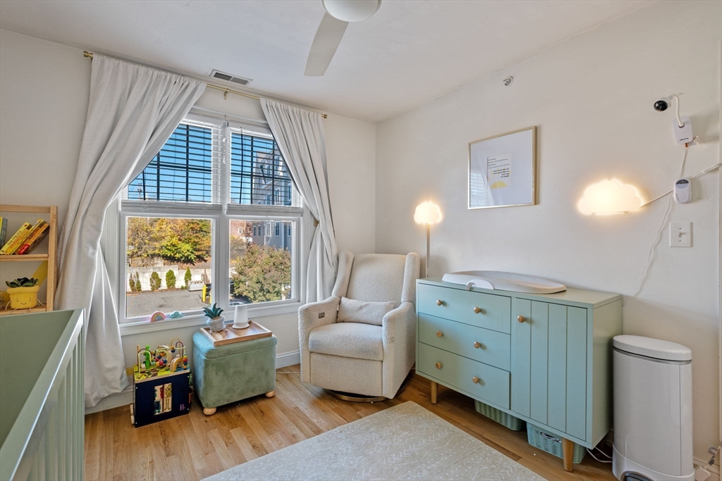 133 Eastern Avenue, Unit 8 Lynn, MA 01902 - Photo 20 of 38 a spacious bedroom with a bed and a dresser next to a window
