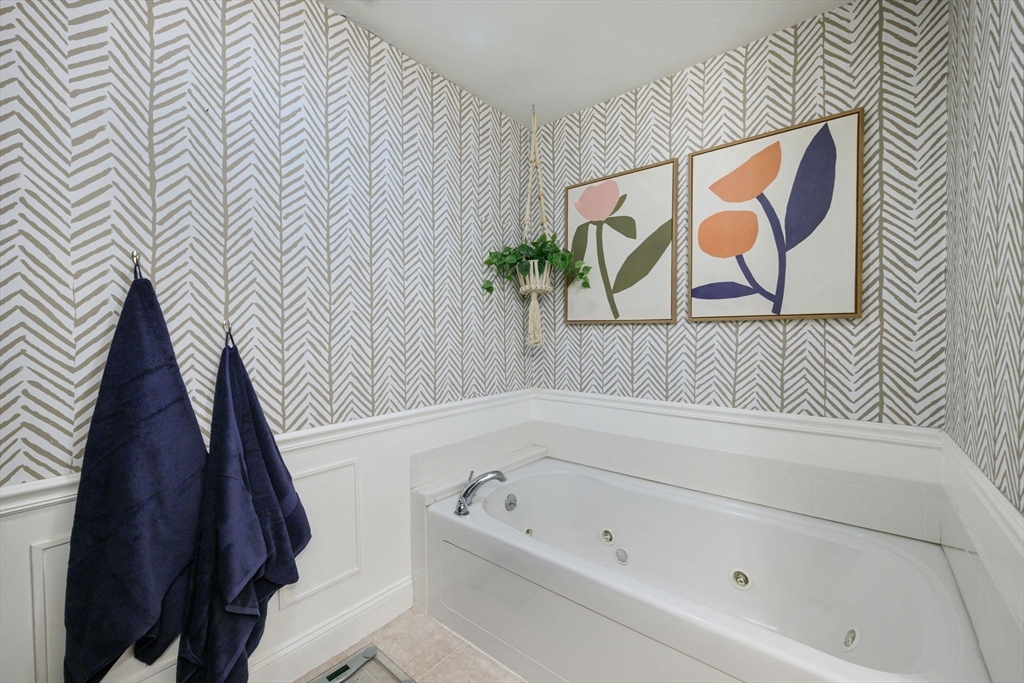 133 Eastern Avenue, Unit 8 Lynn, MA 01902 - Photo 22 of 38 a bathroom with a bathtub and a shower