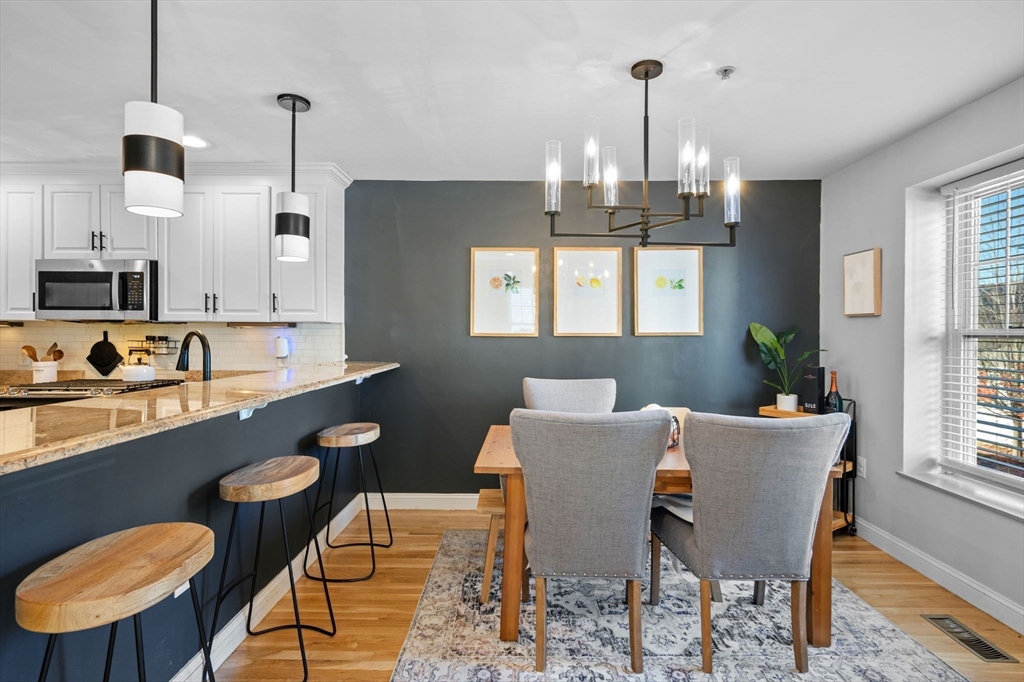 133 Eastern Avenue, Unit 8 Lynn, MA 01902 - Photo 4 of 38 a view of a dining room with furniture window and wooden floor