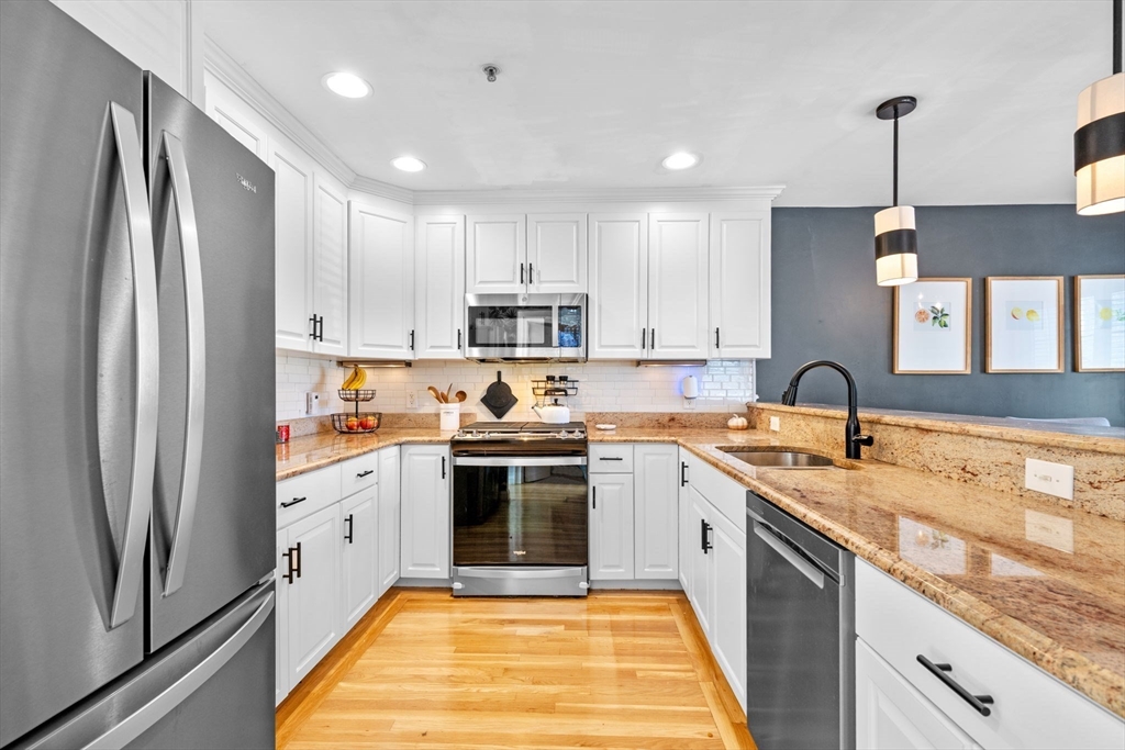 133 Eastern Avenue, Unit 8 Lynn, MA 01902 - Photo 6 of 38 a kitchen with stainless steel appliances granite countertop a sink stove and refrigerator