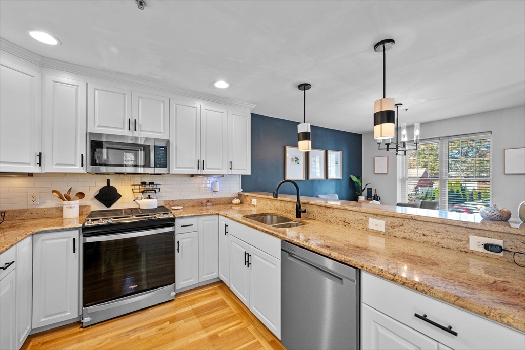 133 Eastern Avenue, Unit 8 Lynn, MA 01902 - Photo 9 of 38 a kitchen with a sink stove and cabinets