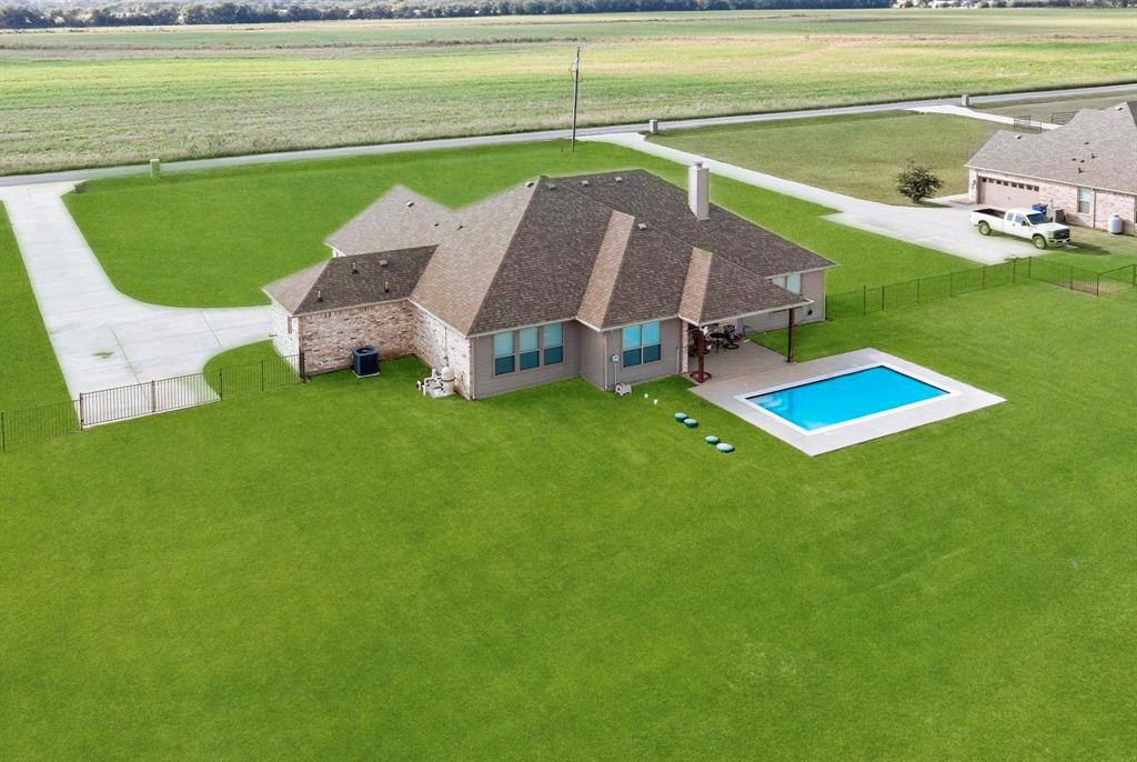 634 Gant Road Sherman, TX 75090 - Photo 39 of 40 Expansive lot featuring a single-story residence with a multi-gabled roof, a rectangular swimming pool with surrounding deck, and a concrete driveway