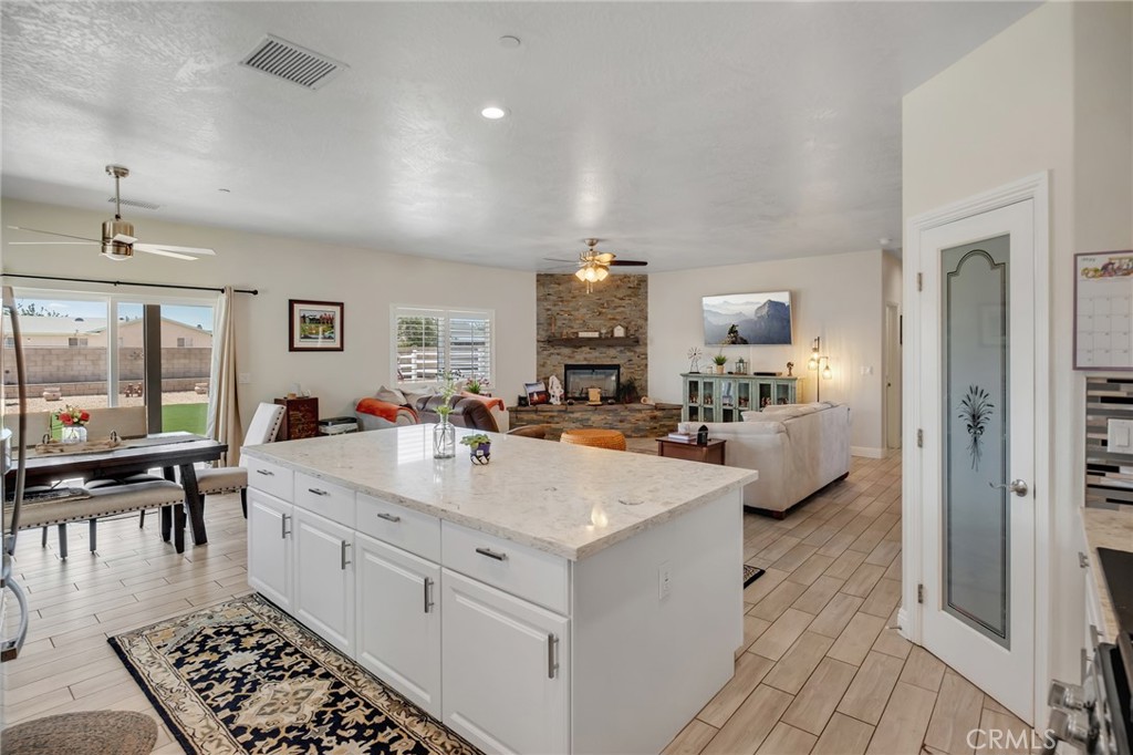 13178 Setancket Road Apple Valley, CA 92308 - Photo 10 of 24 a large white kitchen with a large window
