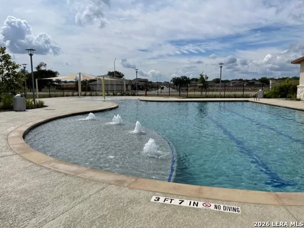 a view of a swimming pool and an outdoor seating
