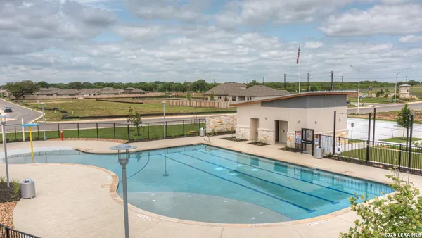 a view of a swimming pool with an outdoor seating