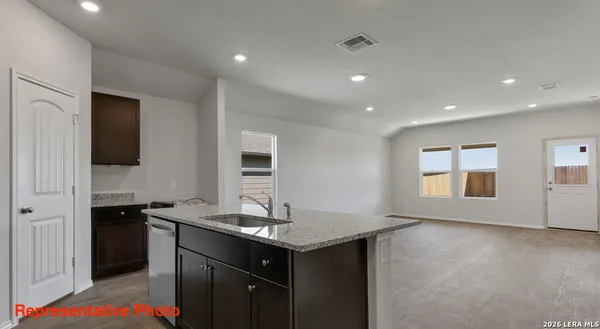 a kitchen with a sink stove and cabinets