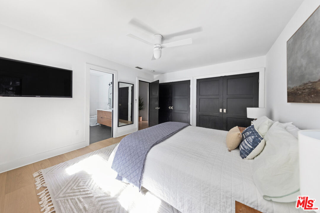 1101 Heatherside Road Pasadena, CA 91105 - Photo 12 of 44 a spacious bedroom with a bed and a flat screen tv