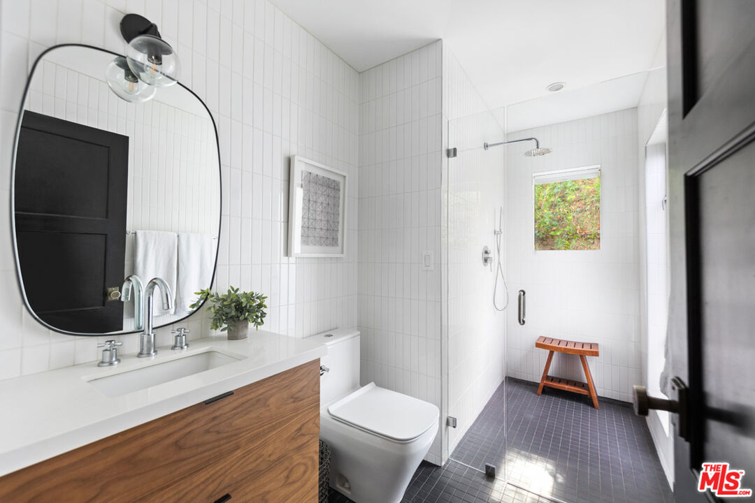 1101 Heatherside Road Pasadena, CA 91105 - Photo 19 of 44 a bathroom with a granite countertop sink toilet and mirror