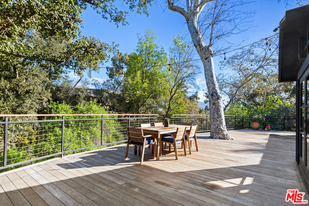 1101 Heatherside Road Pasadena, CA 91105 - Photo 27 of 44 a view of a patio with table and chairs with wooden floor and fence