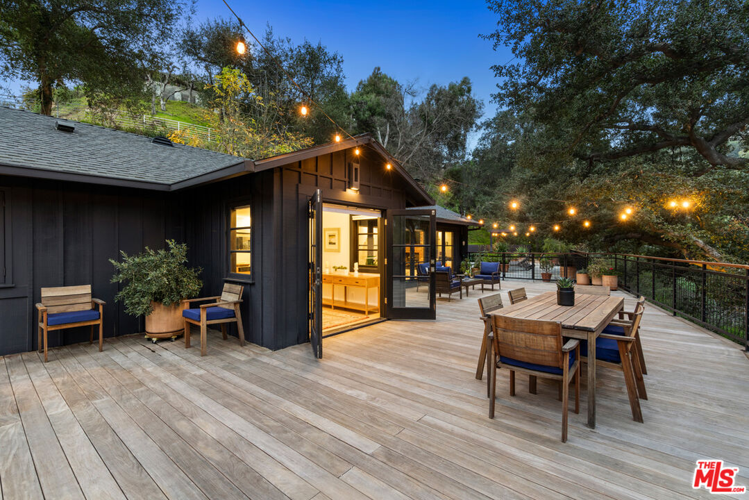 1101 Heatherside Road Pasadena, CA 91105 - Photo 38 of 44 a view of a patio with table and chairs potted plants and floor to ceiling window