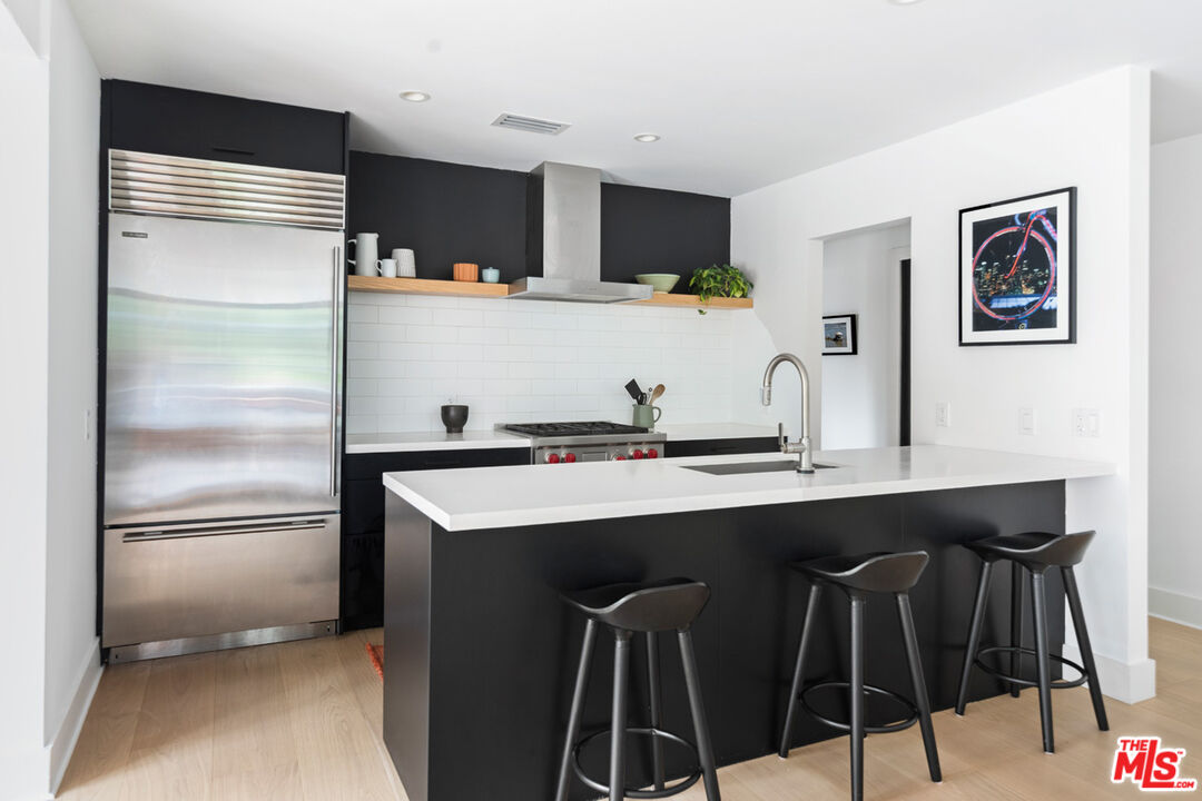 1101 Heatherside Road Pasadena, CA 91105 - Photo 8 of 44 a kitchen with stainless steel appliances a sink and cabinets