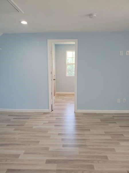 209 Campus Street Ferris, TX 75125 - Photo 12 of 33 a view of wooden floor and windows in a room
