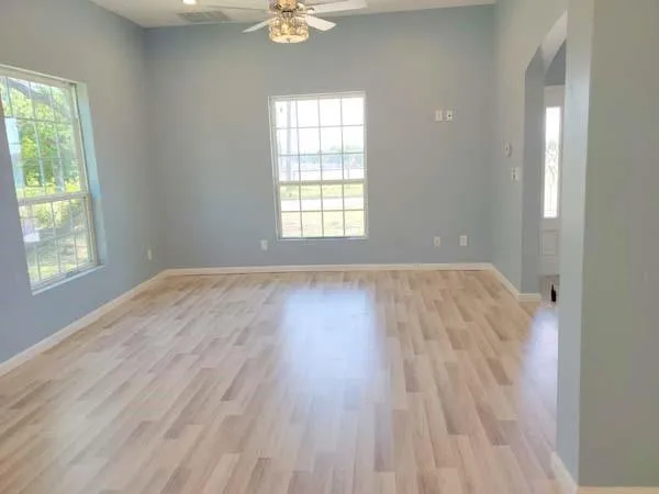 a kitchen with granite countertop a sink window and cabinets