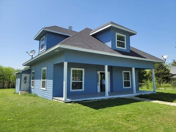 209 Campus Street Ferris, TX 75125 - Photo 2 of 33 a front view of a house with a yard