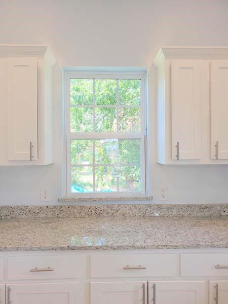 209 Campus Street Ferris, TX 75125 - Photo 24 of 33 a view of a kitchen that has a sink window and a counter top space