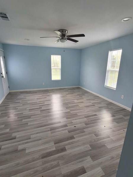 209 Campus Street Ferris, TX 75125 - Photo 26 of 33 wooden floor in an empty room with a window