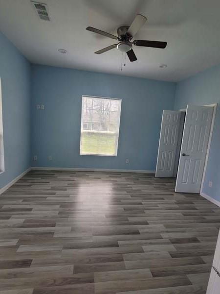 209 Campus Street Ferris, TX 75125 - Photo 27 of 33 a view of an empty room with wooden floor and a window