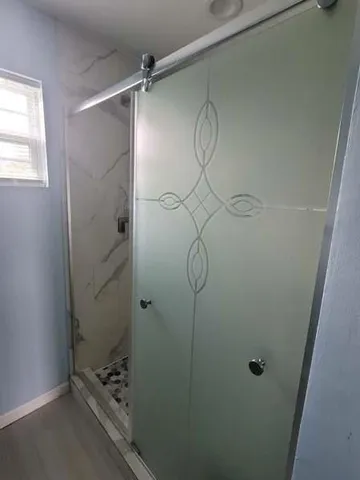 a view of wooden floor and a floor to ceiling window