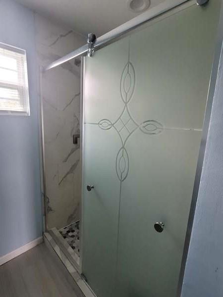 209 Campus Street Ferris, TX 75125 - Photo 29 of 33 a bathroom with a glass shower door