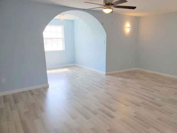 209 Campus Street Ferris, TX 75125 - Photo 9 of 33 an empty room with wooden floor and windows