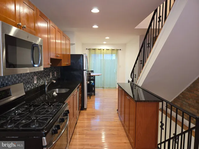a kitchen with granite countertop a stove and a sink