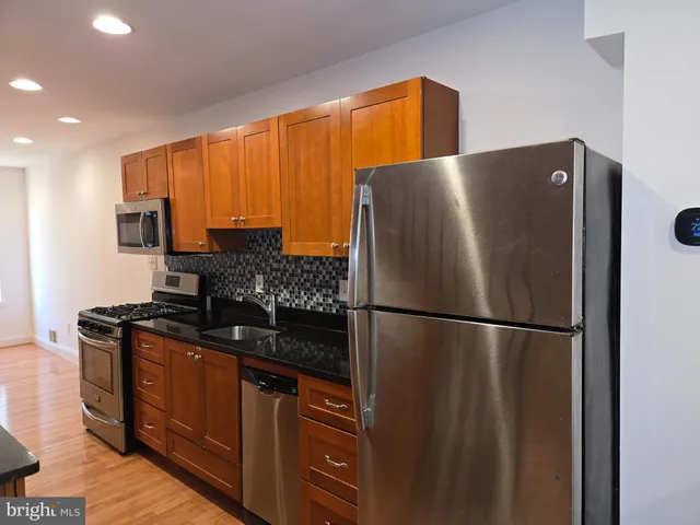 a white refrigerator freezer sitting in a kitchen