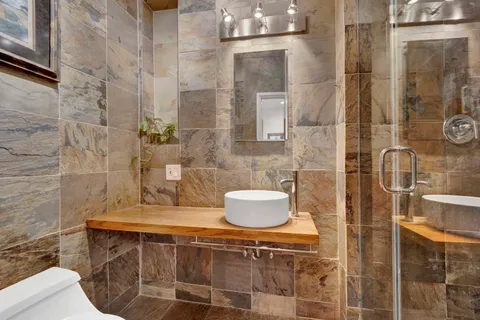 a bathroom with a sink toilet and shower
