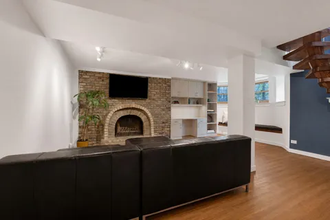 a living room with fireplace furniture and a flat screen tv