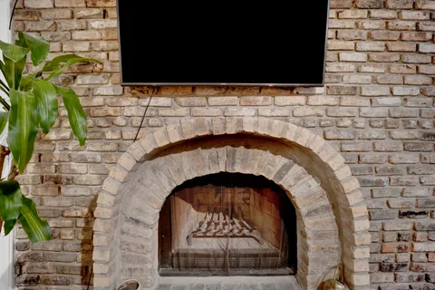 a stone fireplace with a sink
