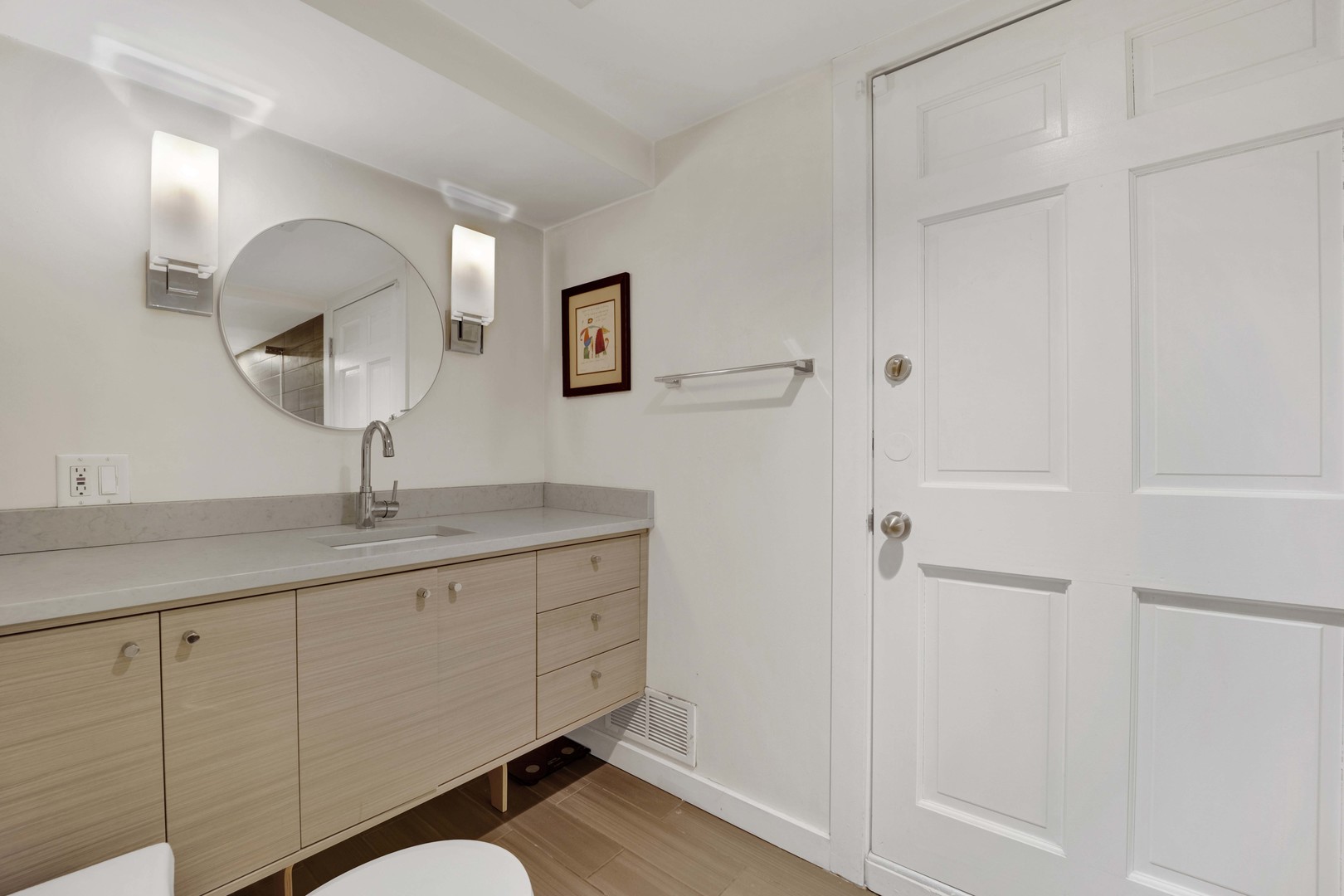 634 West Grace Street, Unit 1E Chicago, IL 60613 - Photo 21 of 26 a bathroom with a sink a light fixture and a mirror