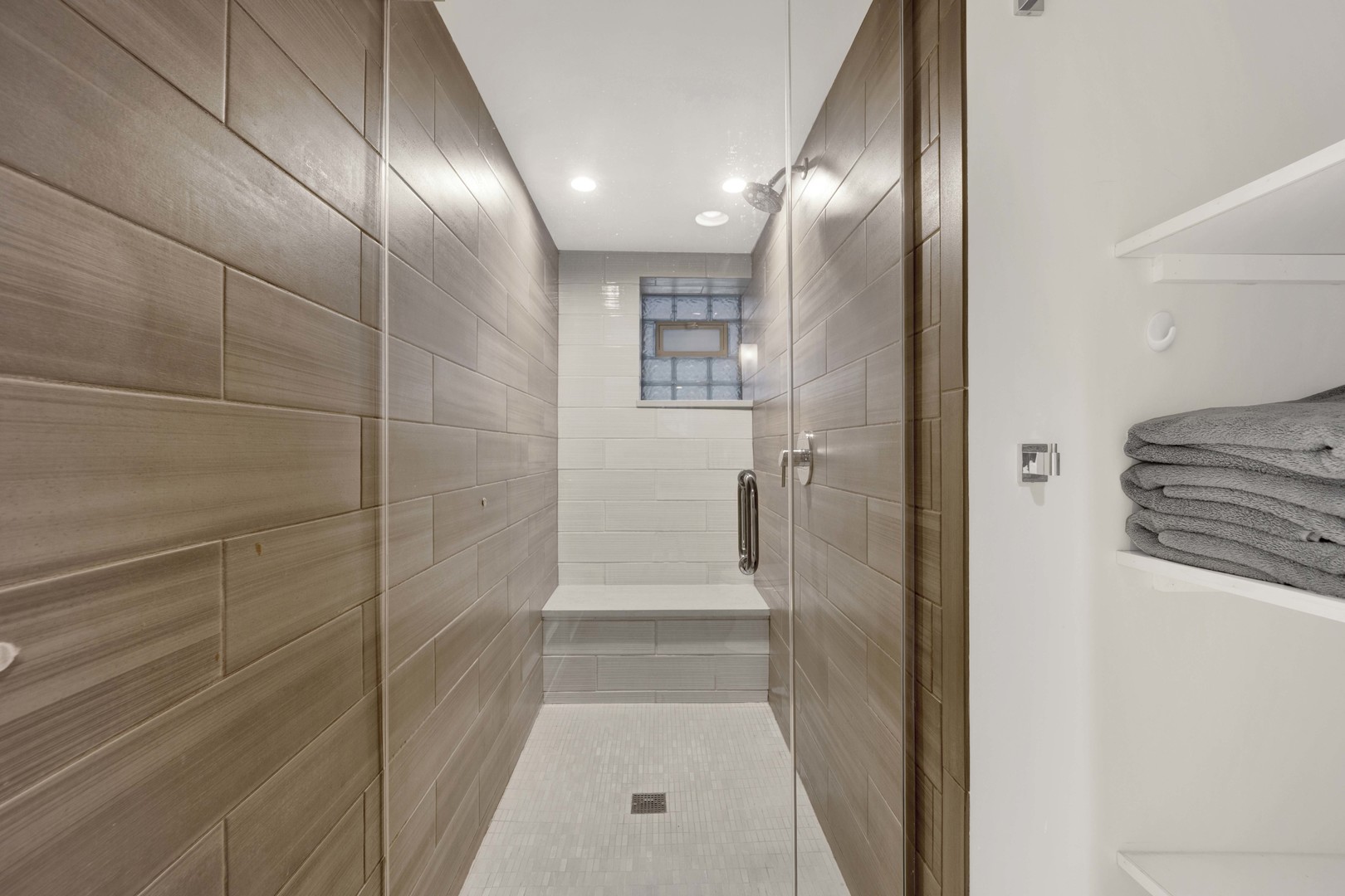 634 West Grace Street, Unit 1E Chicago, IL 60613 - Photo 22 of 26 a bathroom with a glass shower door