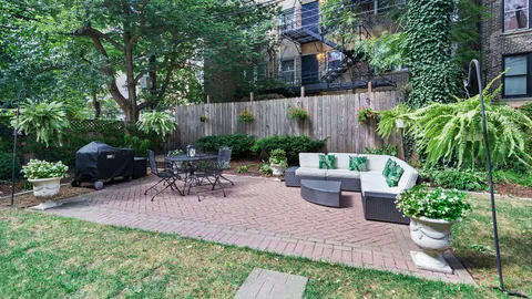 a view of a backyard with sitting area and garden