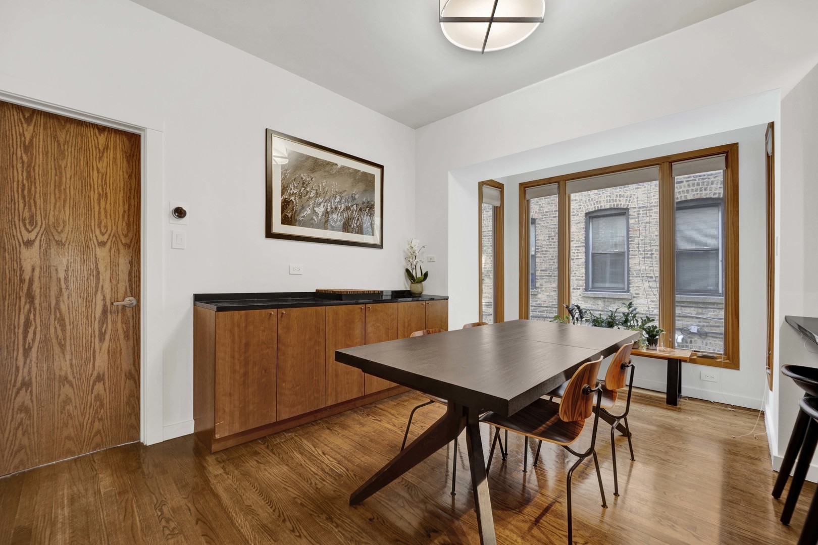 634 West Grace Street, Unit 1E Chicago, IL 60613 - Photo 5 of 26 a view of a dining room with furniture and wooden floor
