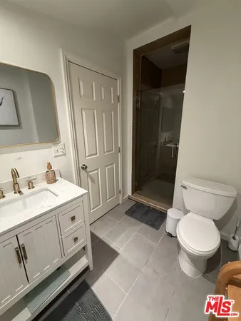 a utility room with a sink and mirror