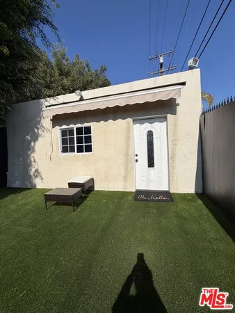 a view of a backyard with table and chairs