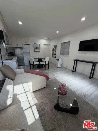 a spacious bedroom with a bed and a cabinets