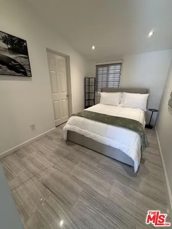 a bedroom with a bed and a couch