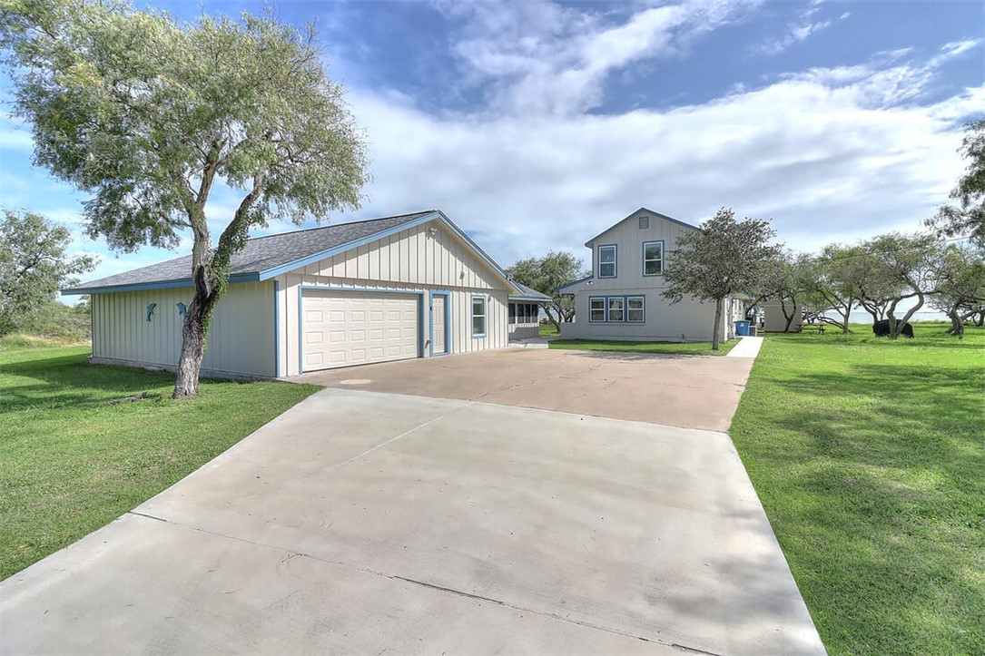 1010 1st Street Bayside, TX 78340 - Photo 1 of 40 a view of house with a big yard potted plants and large tree