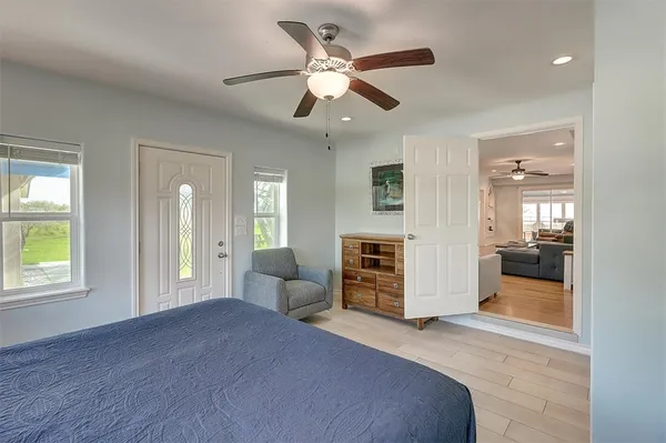 a bedroom with furniture and a large window