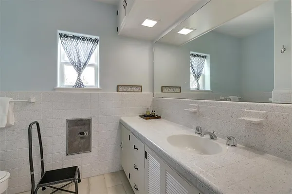a bathroom with a double vanity sink and a mirror