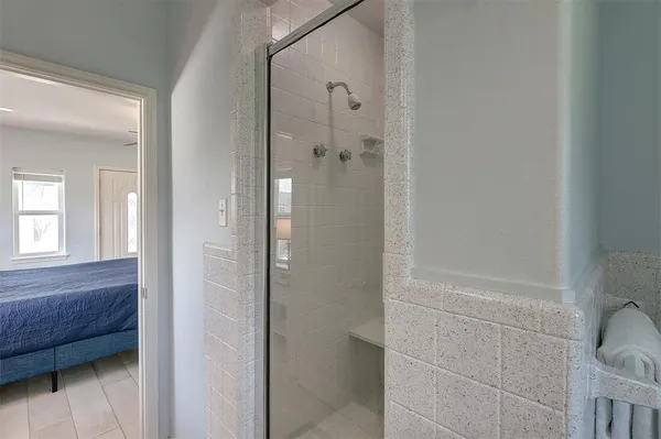a bathroom with a shower and a sink