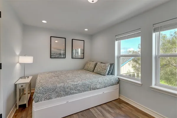 a bedroom with a large bed and a night stand