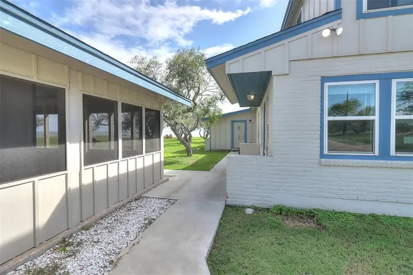 a view of a house with backyard and porch