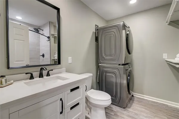 a bathroom with a sink a toilet mirror and vanity
