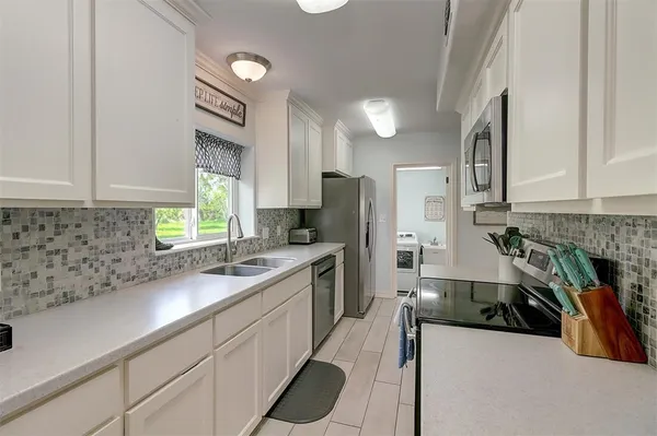 a kitchen with stainless steel appliances kitchen island granite countertop a sink and cabinets