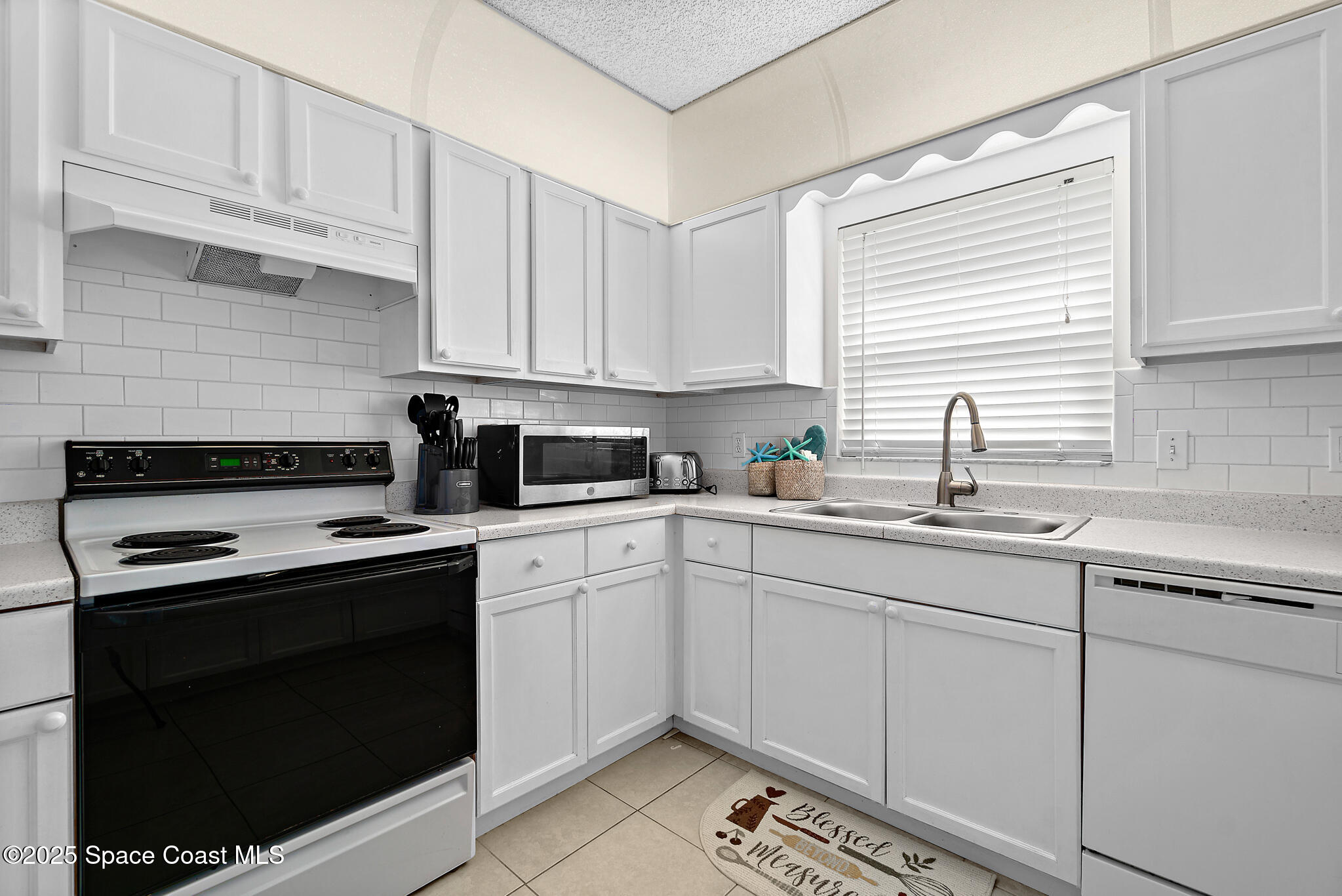 147-159 Ocean View Lane Melbourne, FL 32903 - Photo 13 of 48 a kitchen with cabinets appliances a sink and a window