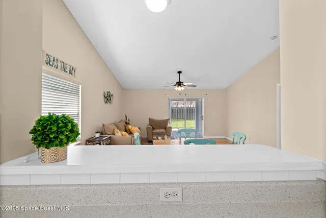 a view of a dining room with furniture and a kitchen