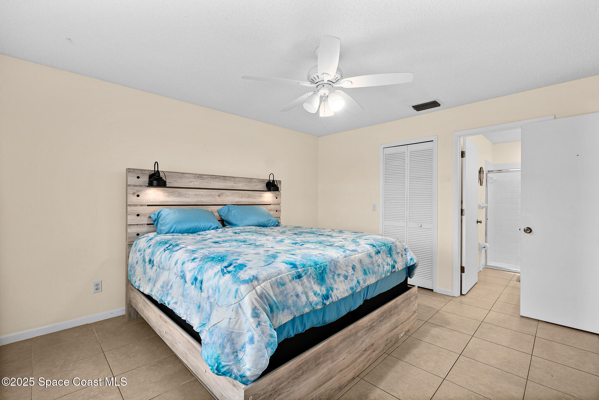 147-159 Ocean View Lane Melbourne, FL 32903 - Photo 24 of 48 a bedroom with a bed and a ceiling fan