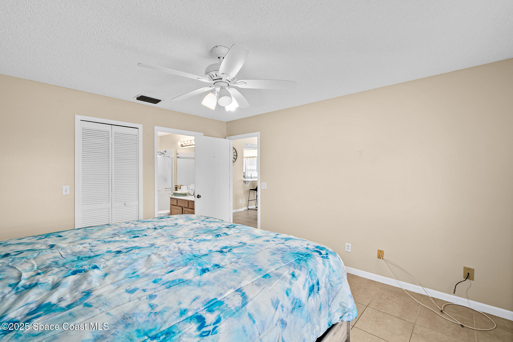 147-159 Ocean View Lane Melbourne, FL 32903 - Photo 25 of 48 a bedroom with a large bed and a chandelier