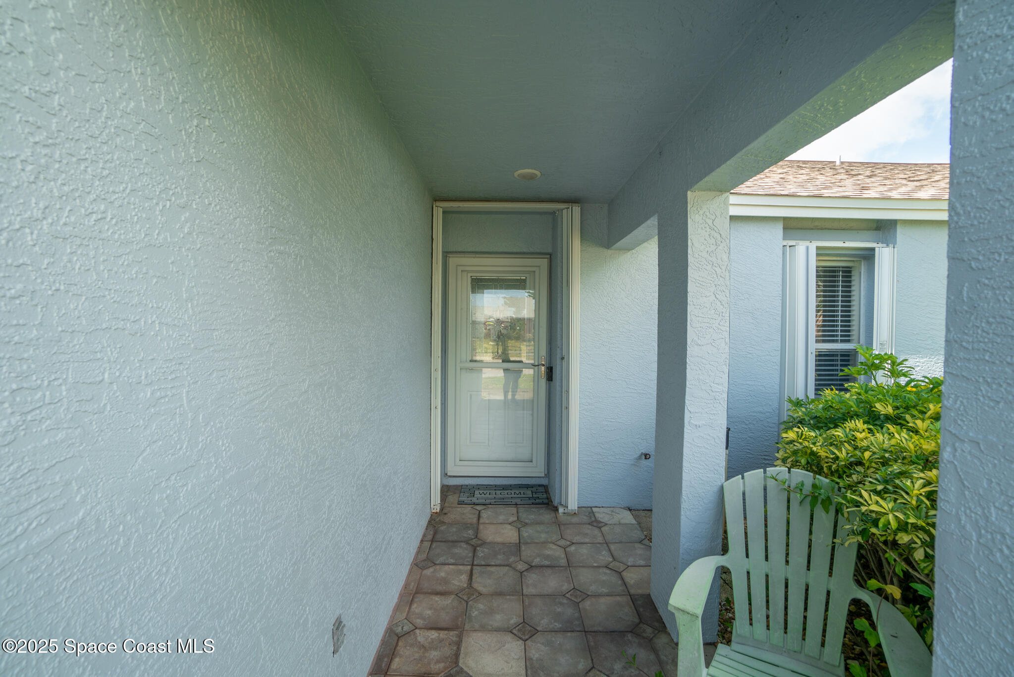 147-159 Ocean View Lane Melbourne, FL 32903 - Photo 4 of 48 a view of a door and chair in the house